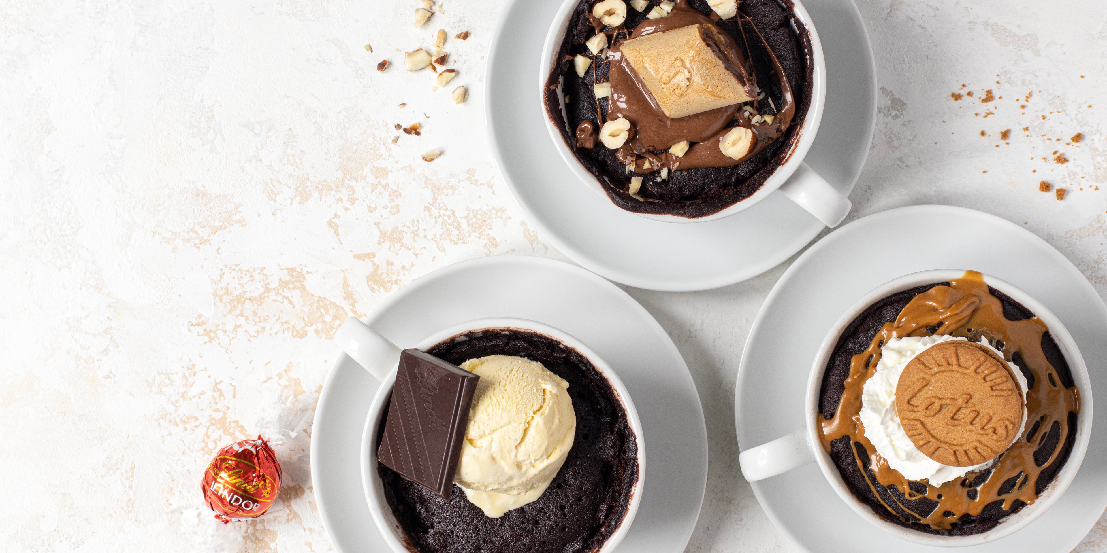 Top view of Chocolate Mug Cakes, customised with Lindt, Nutella and Lotus Biscoff