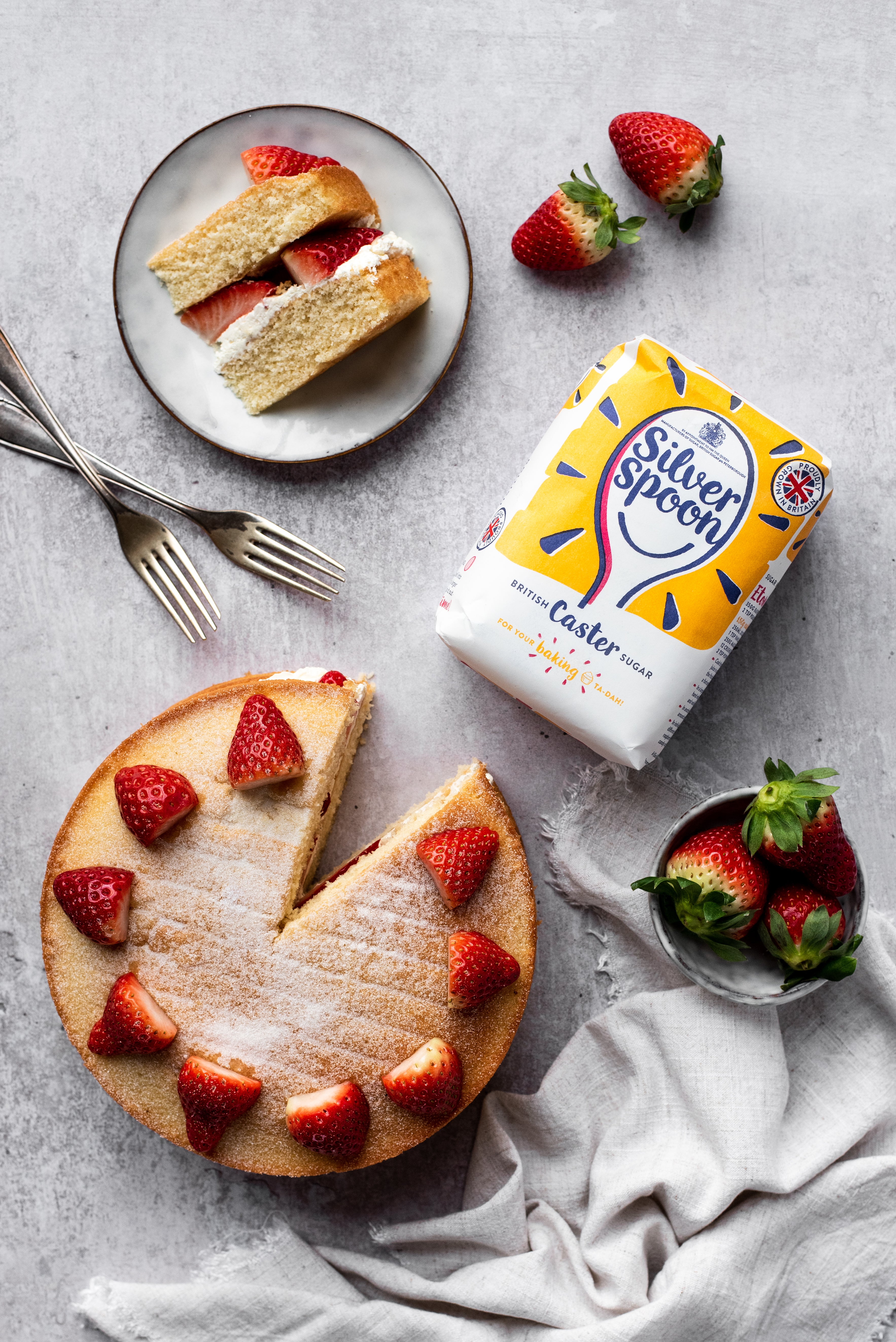 strawberries on top of a sponge cake