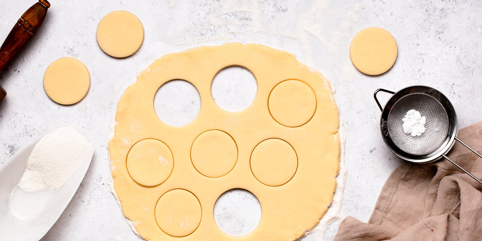 Top down view of vegan shortbread cut out with a circle cookie cutter