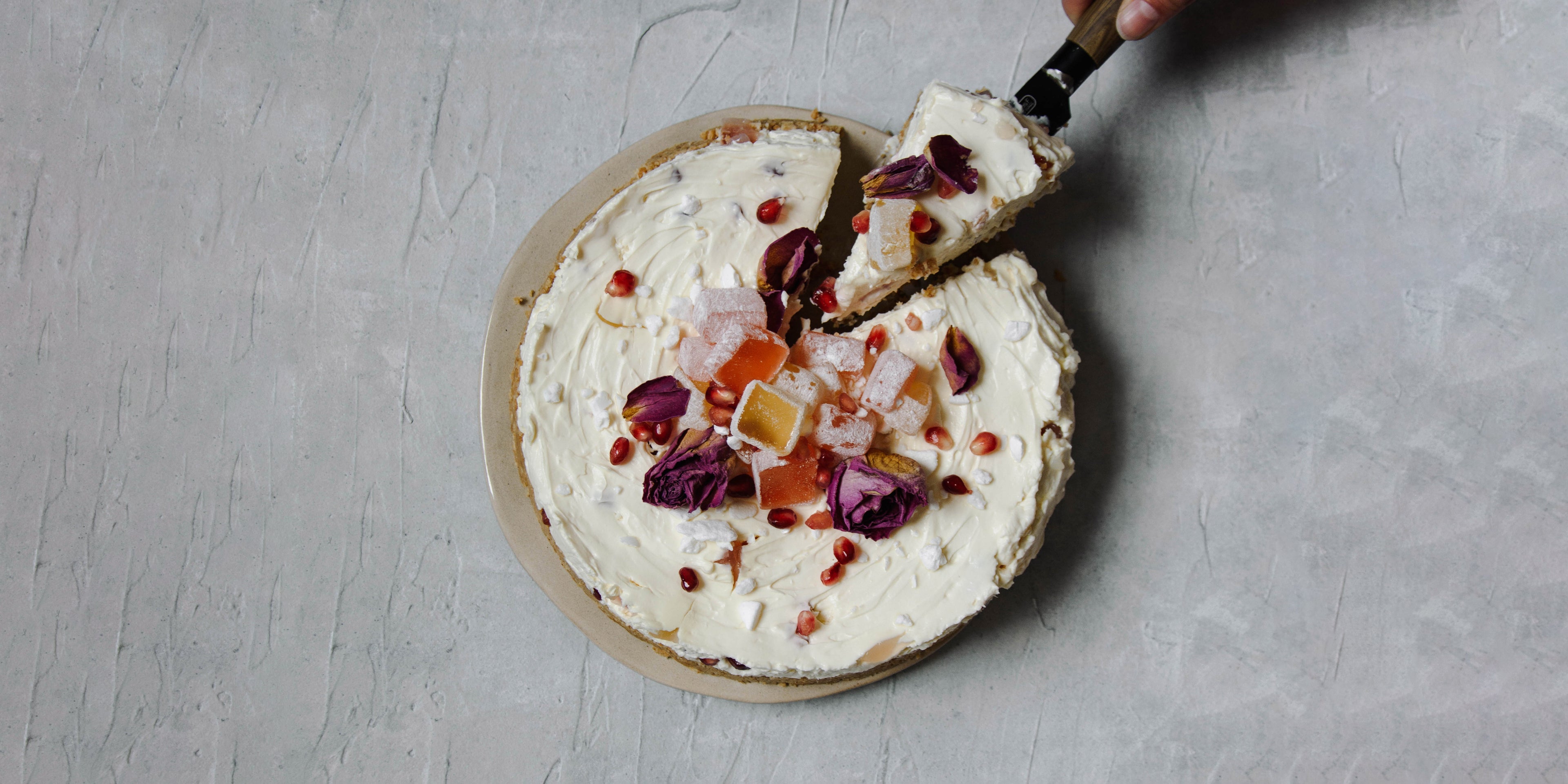 Overhead shot of cheesecake with slice removed and cake slice