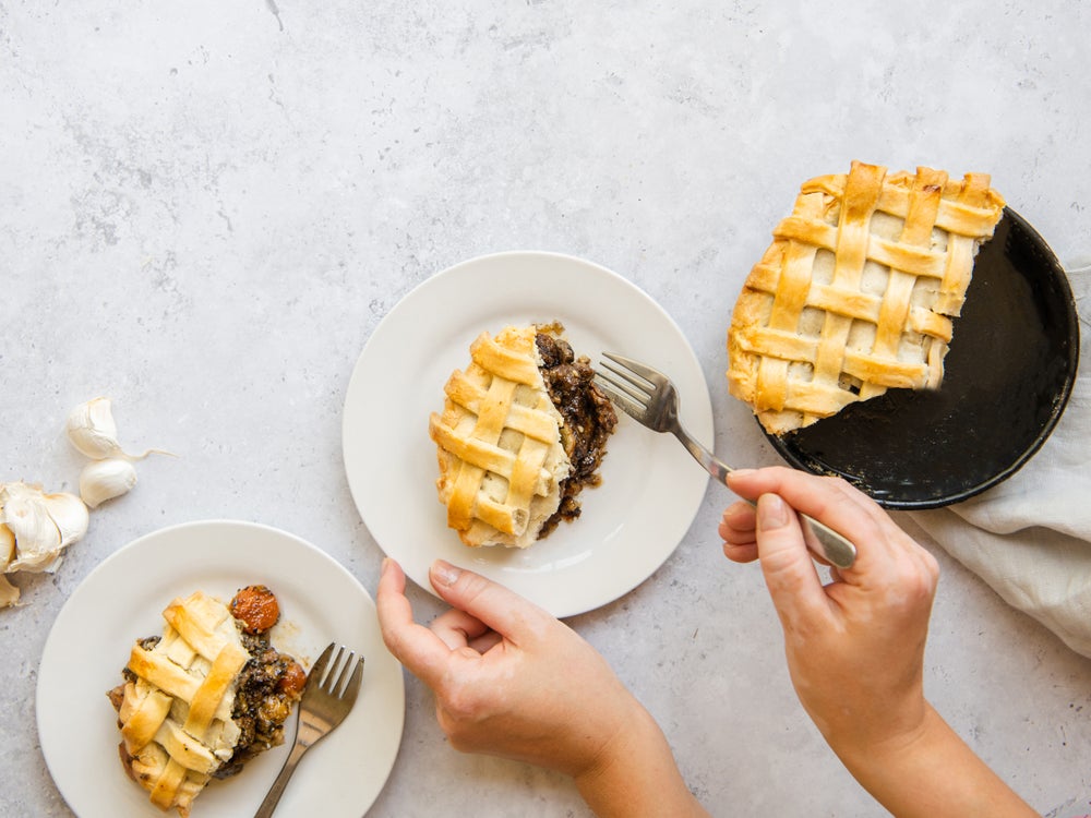 Large slice of freshly-baked steak pie on a white plate