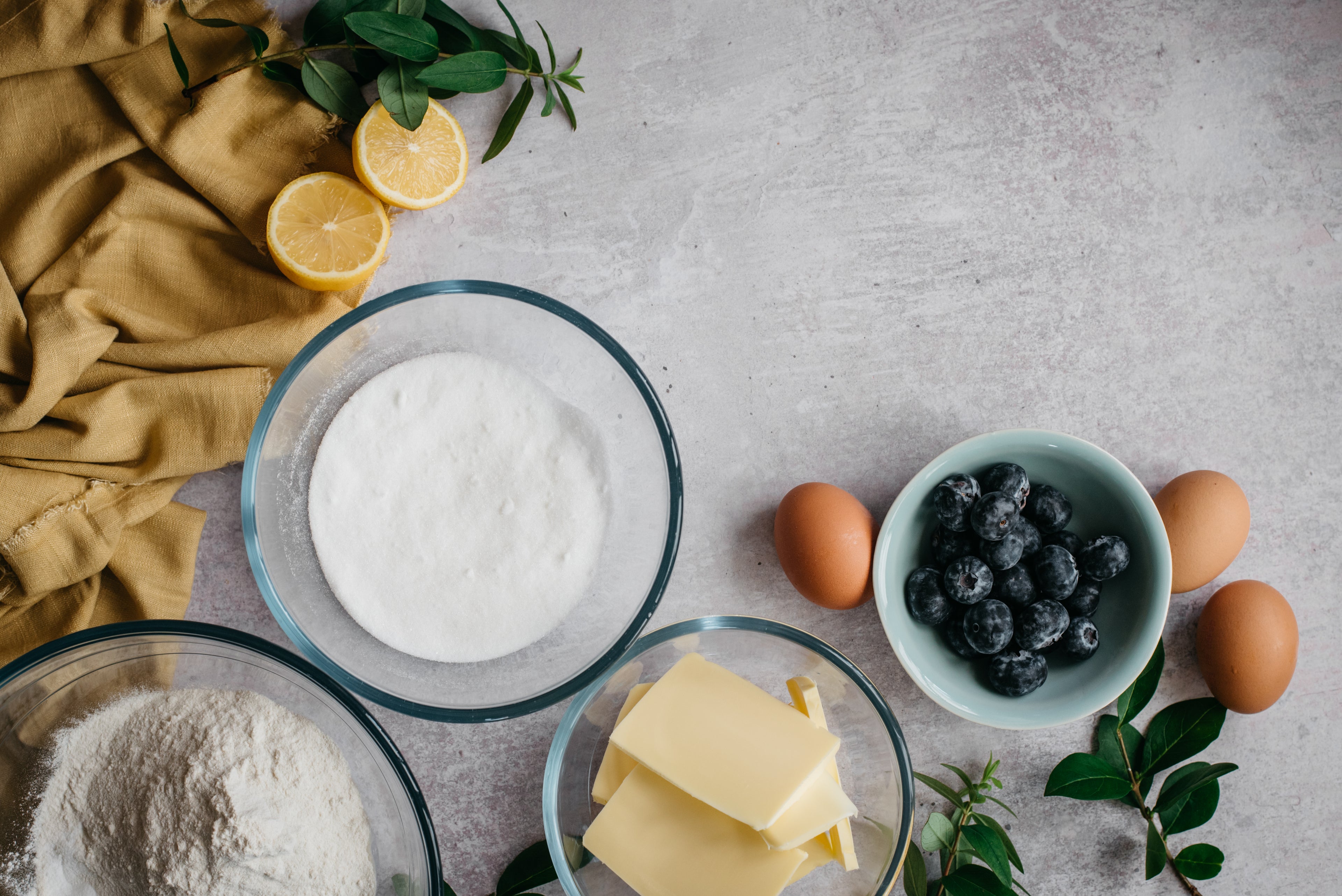 Top down view of ingredients for a low sugar lemon and blueberry traybake