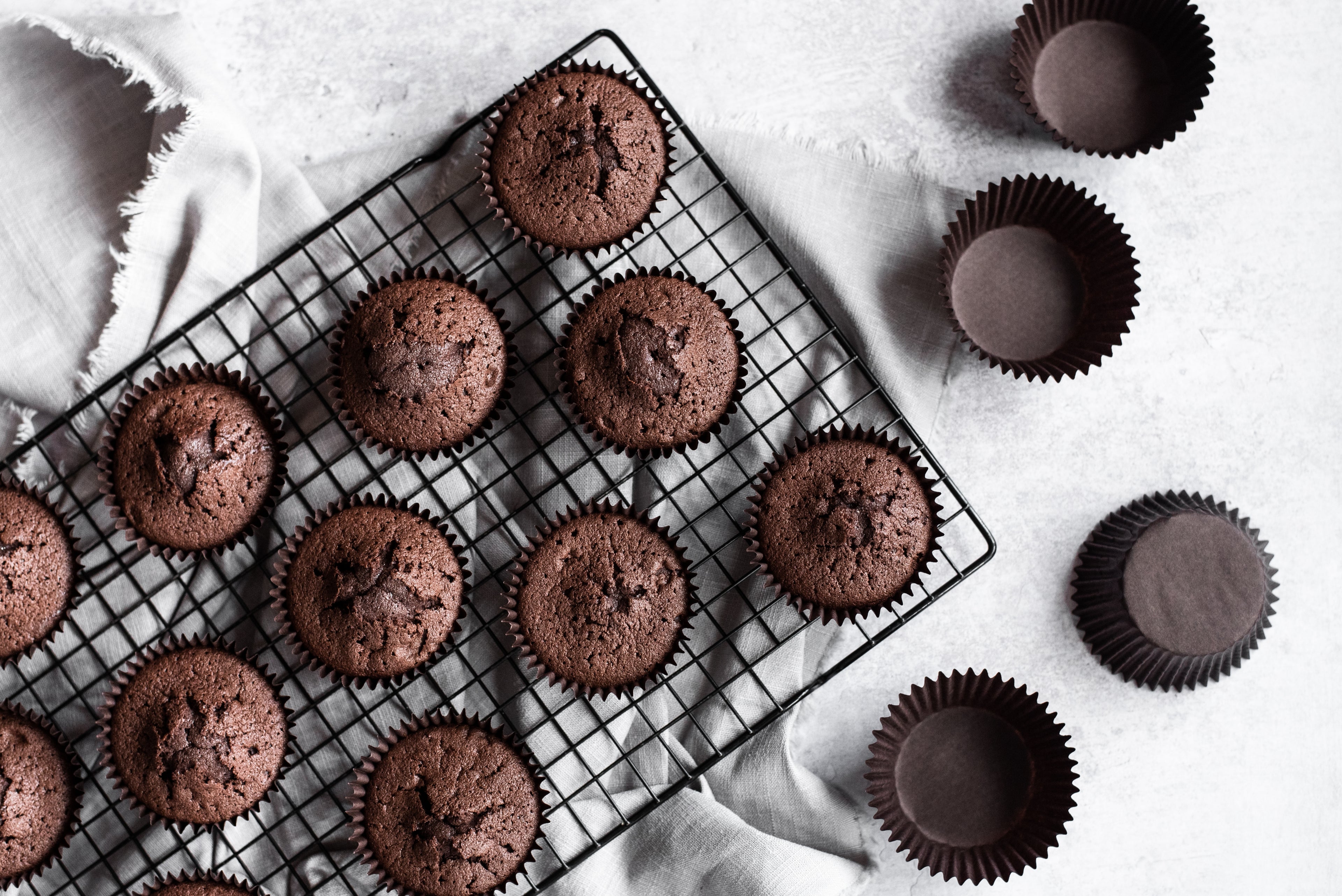 Baked chocolate cupcakes on a cooling rack