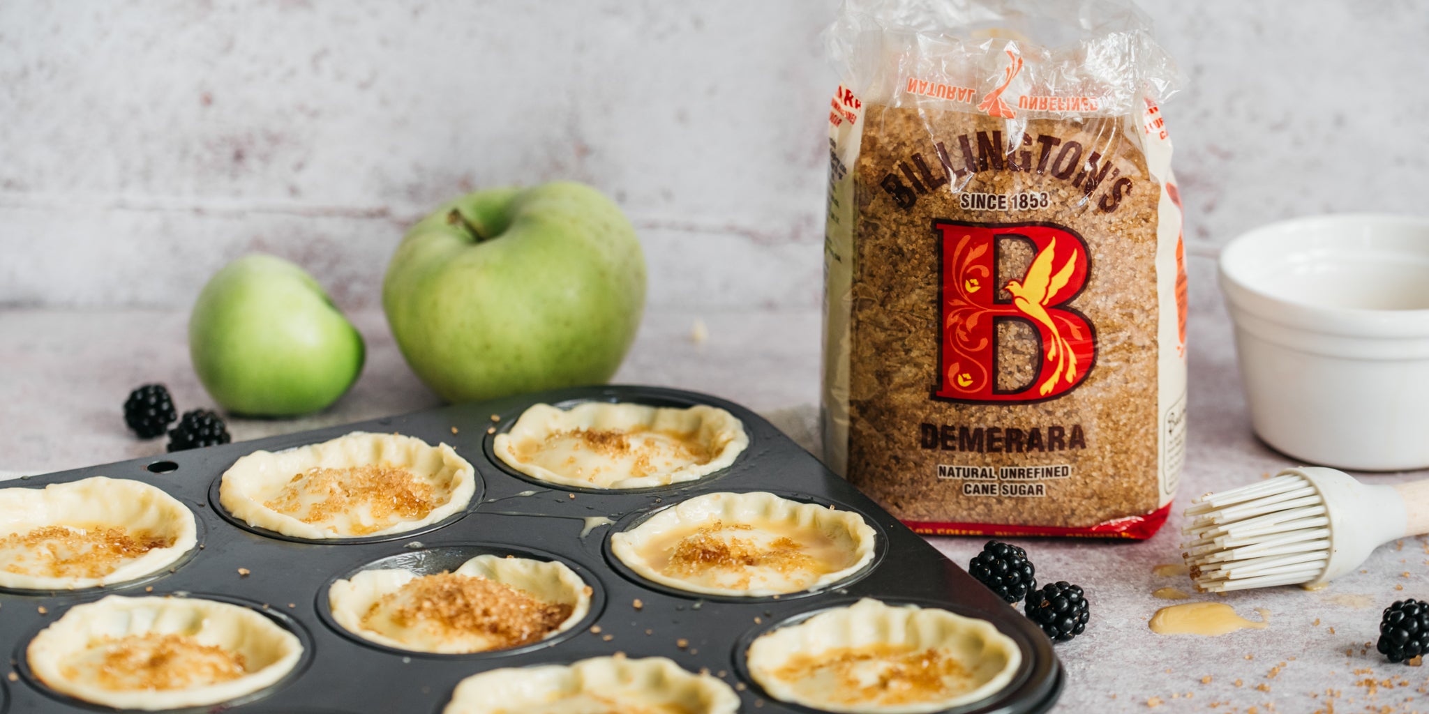 Fruit pies in baking tray with apple and sugar pack