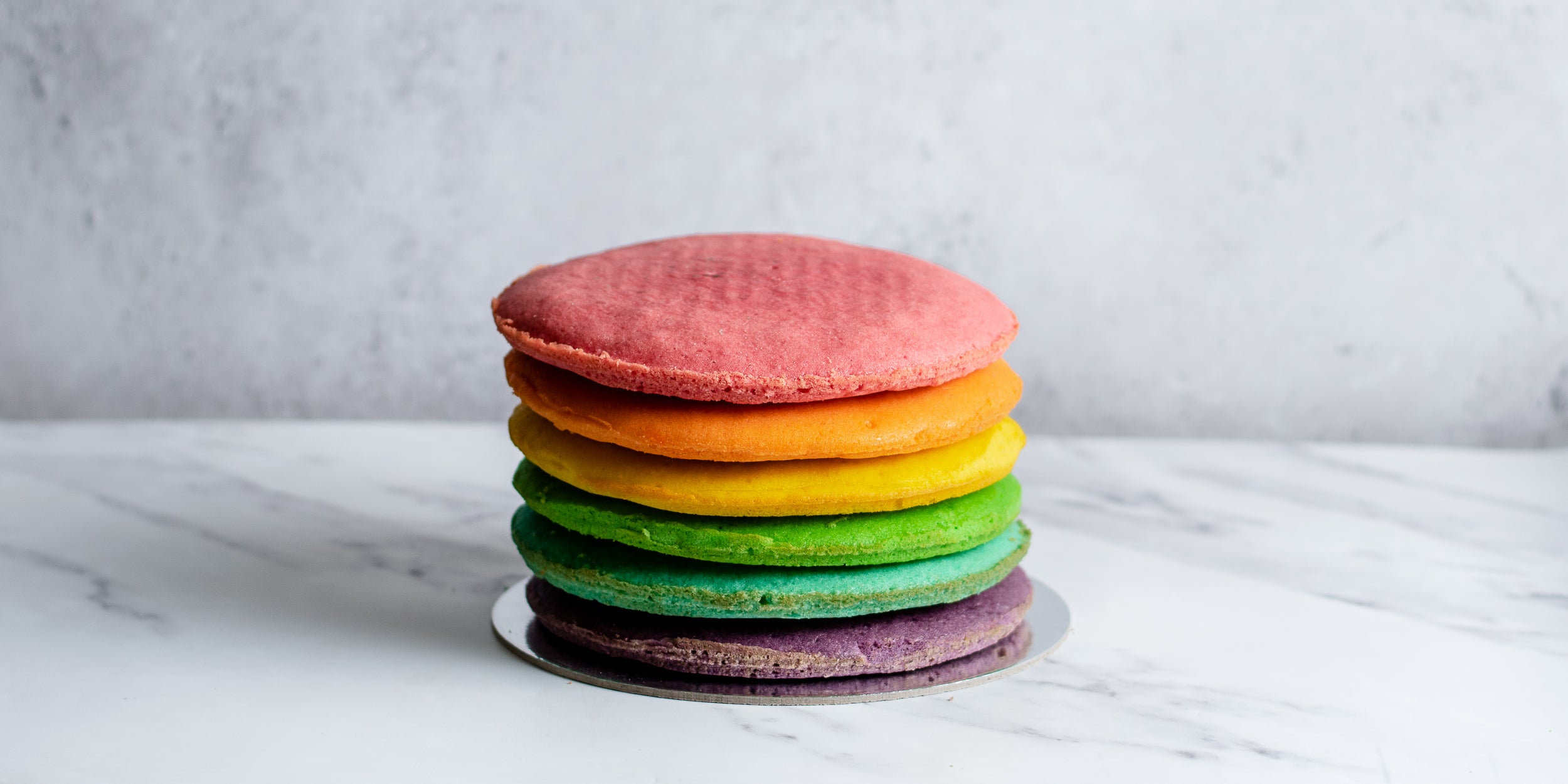 6 layers of rainbow coloured sponges piled on top of each other