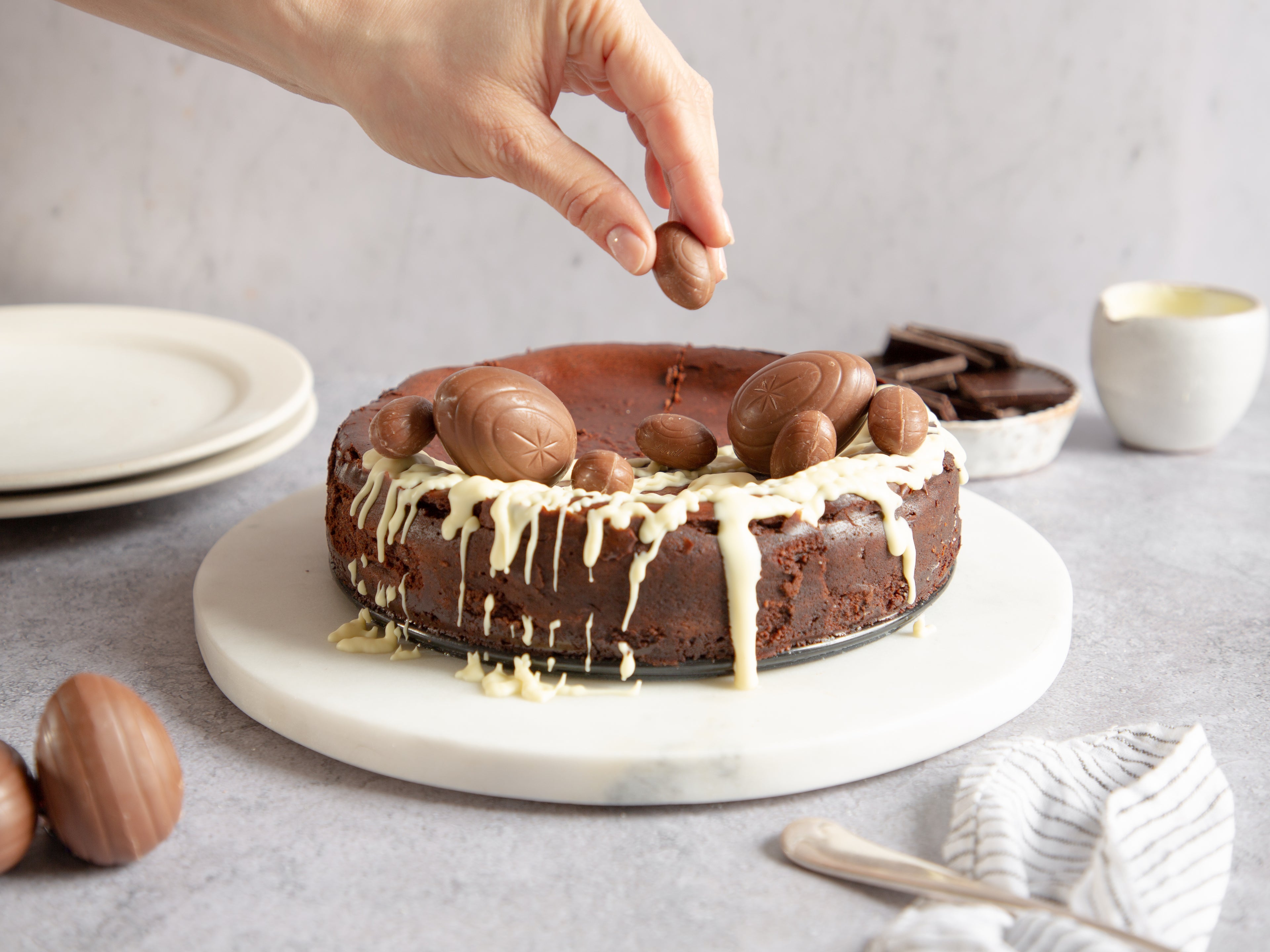 Chocolate Cheesecake being hand finished with chocolate eggs