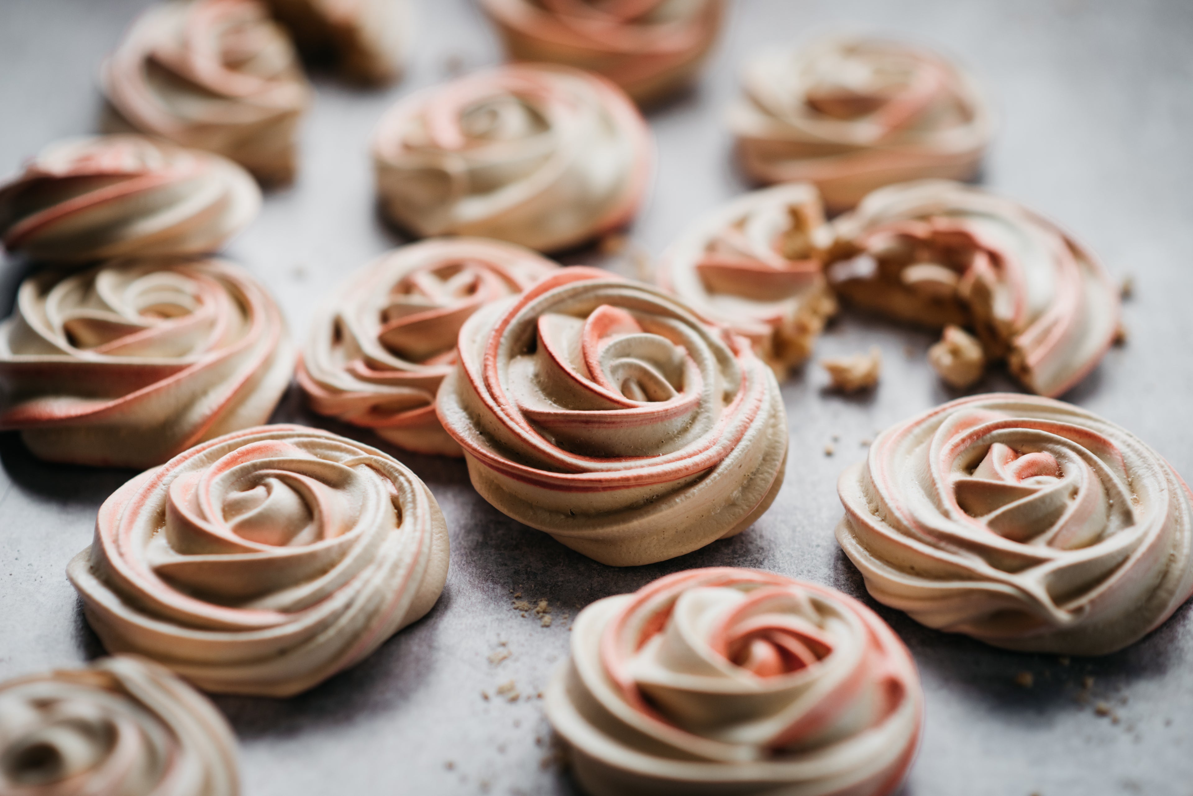 Close up of Vegan Meringue freshly baked out of the oven, with light pink swirls of colour