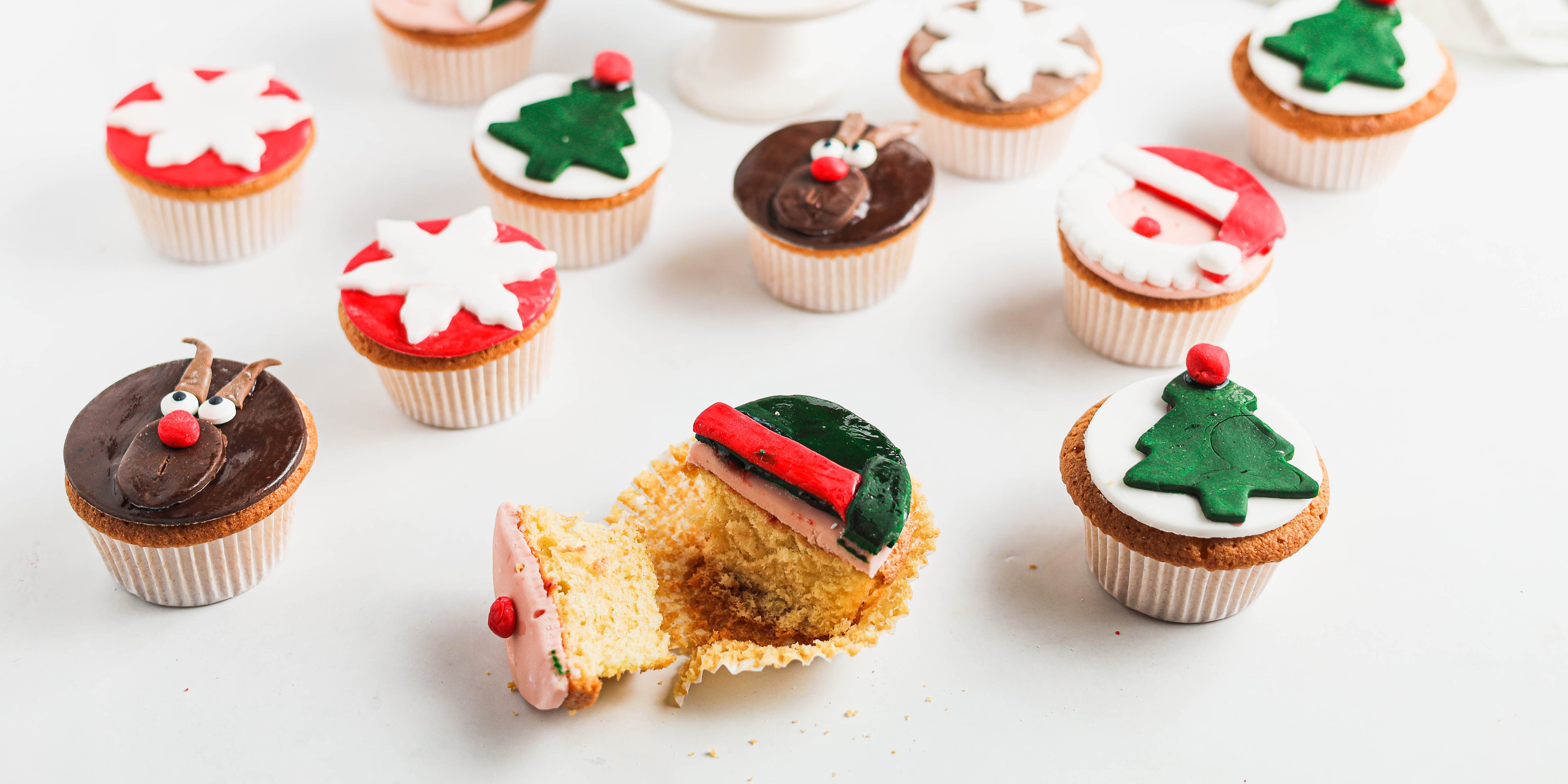 Close up of Christmas Cupcakes with a cupcake cut in half showing the fluffy insides