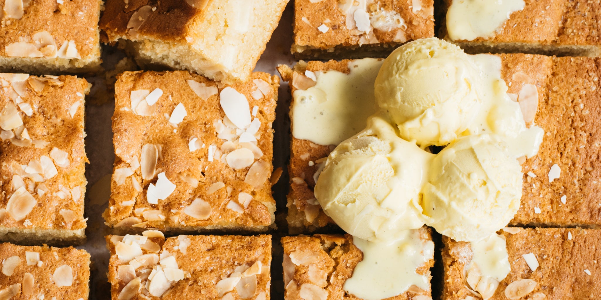 Squares of cake with melted ice cream on top