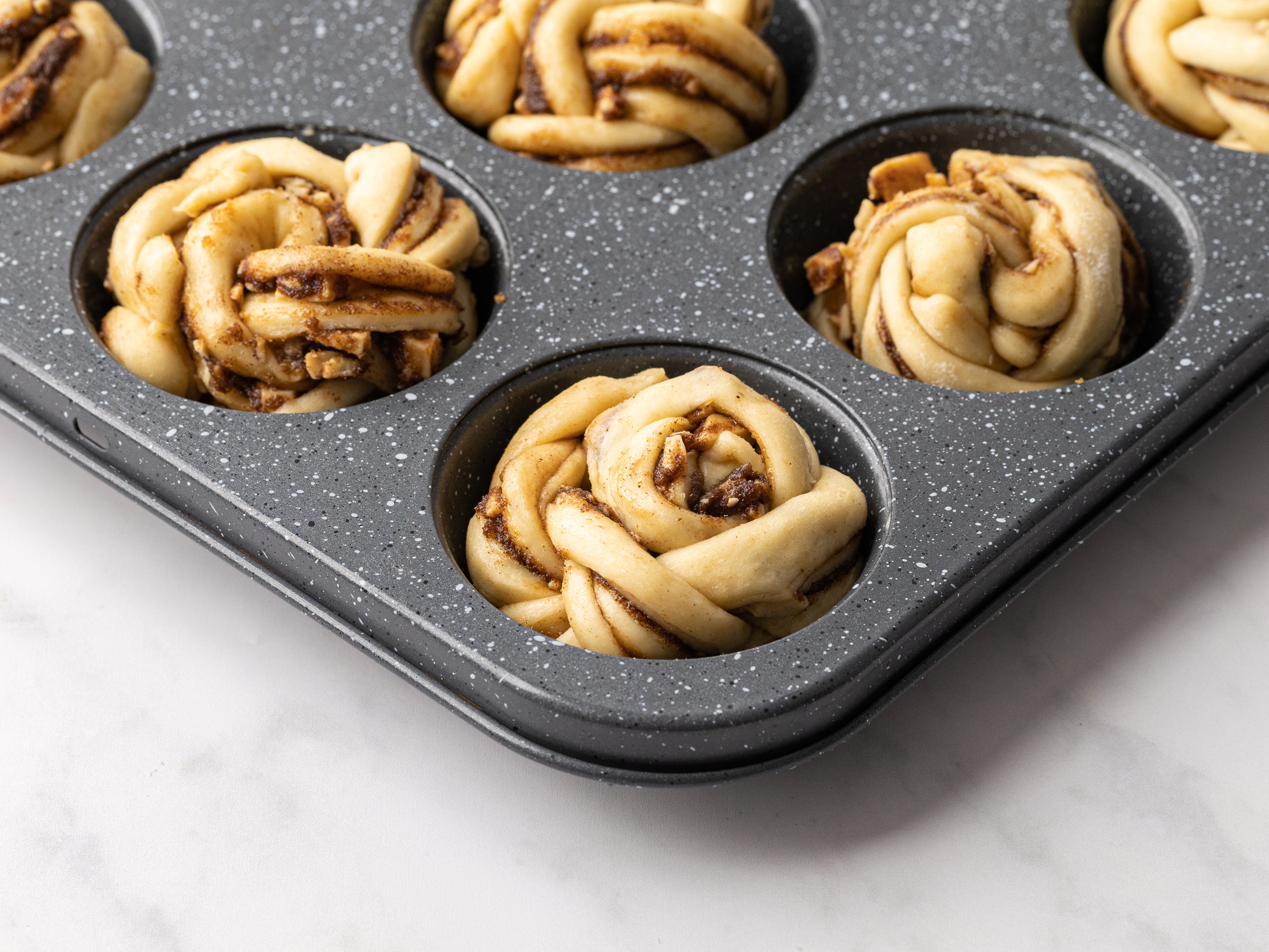 Cinnamon roll knots in muffin tin