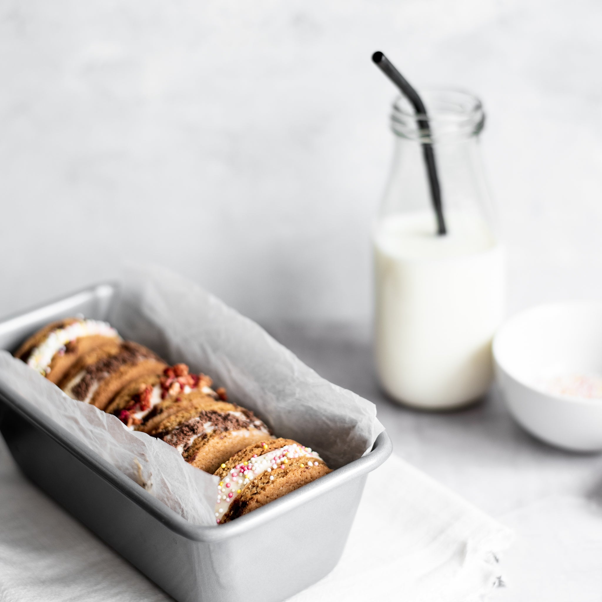 Set of five ice cream sandwiches in a silver loaf tin, stuffed with different ice creams