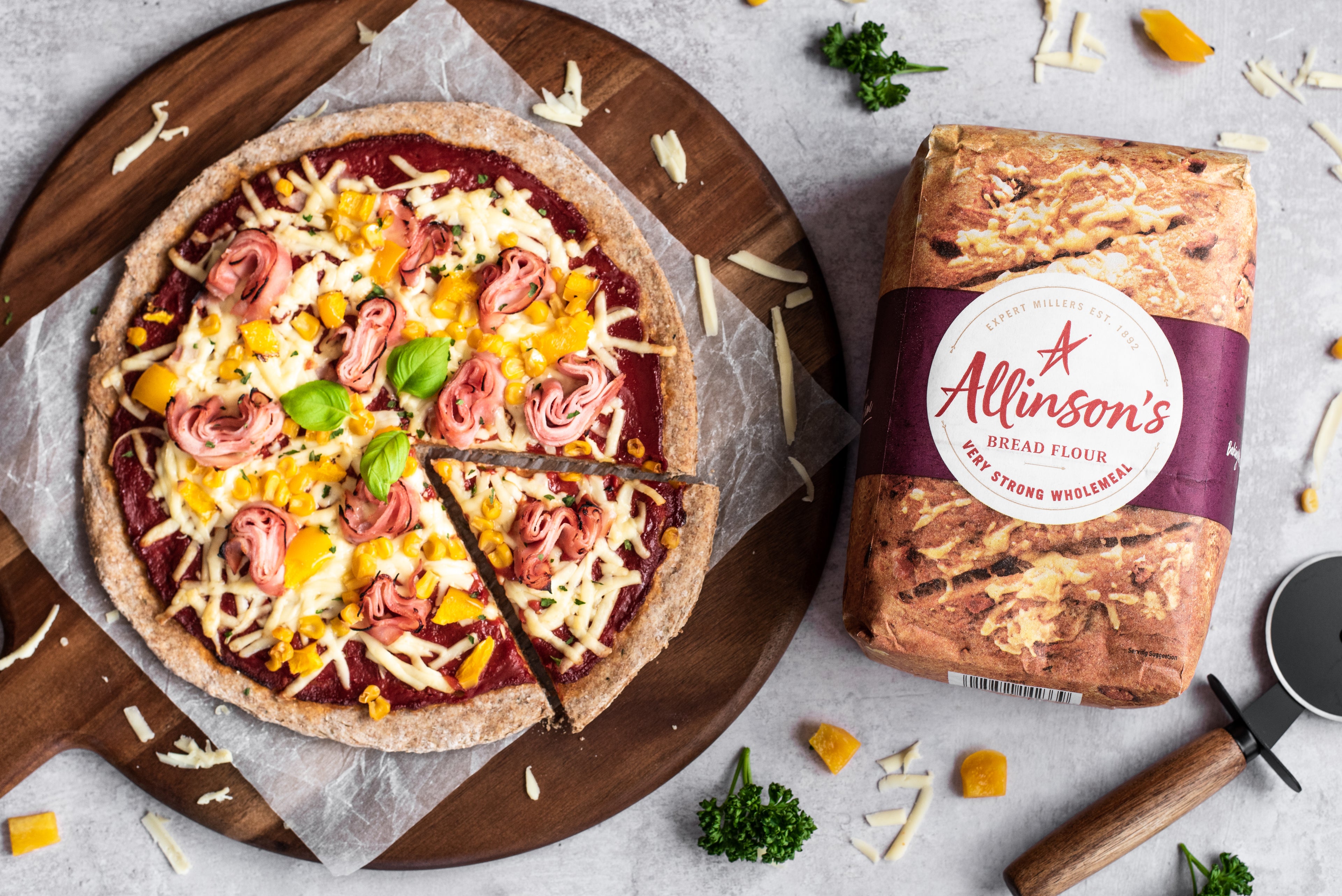 Overhead shot of pizza with slice removed and bread flour