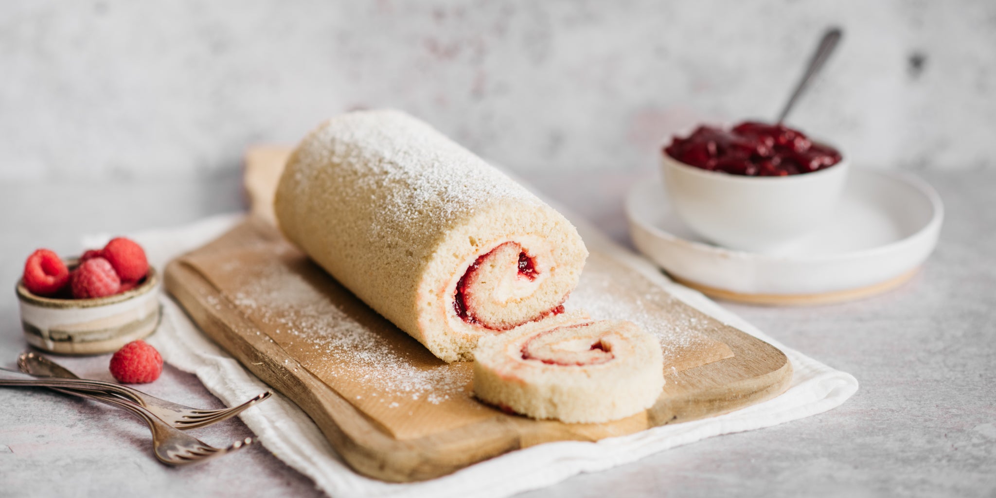 Side on view of a sliced vanilla swiss roll