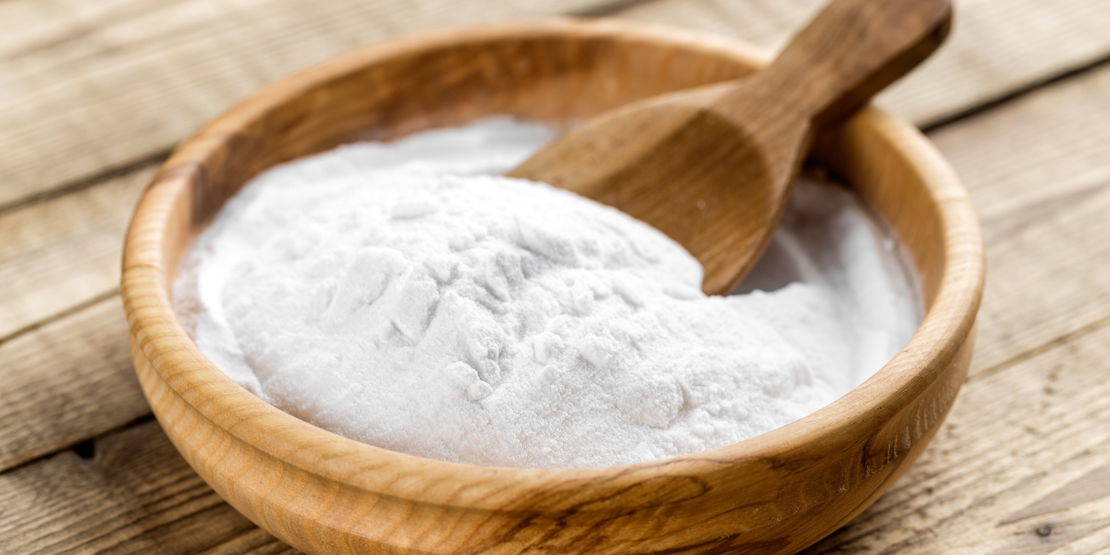 wooden bowl and wooden spoon with baking soda