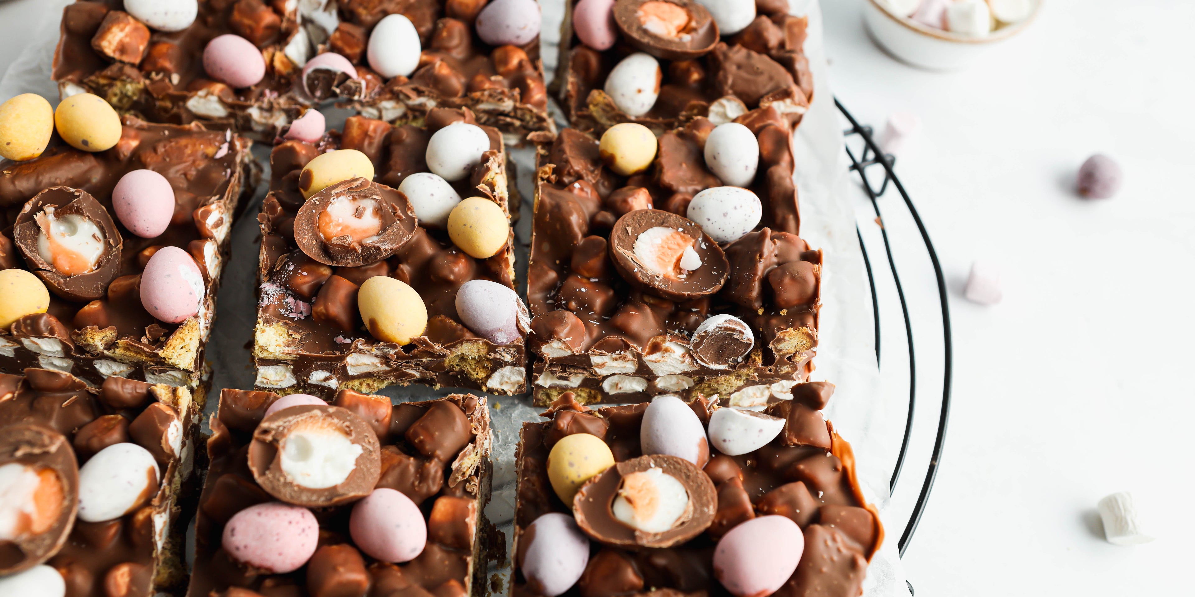 Close up of Easter Egg Rocky Road cut into slices topped with mini eggs, creme eggs and marshmallows