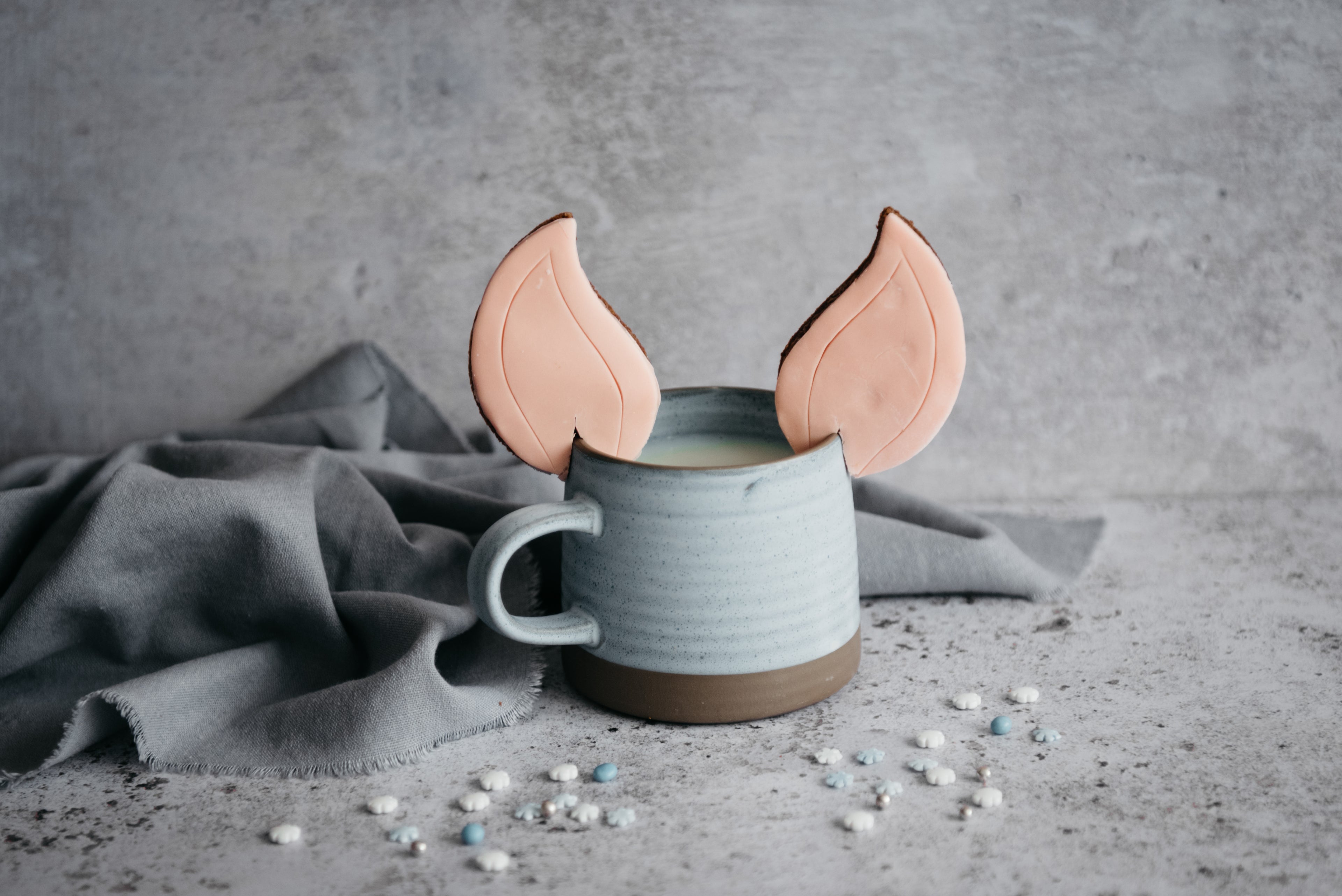 Elf Ears Gingerbread Cookies on the edge of a blue mug