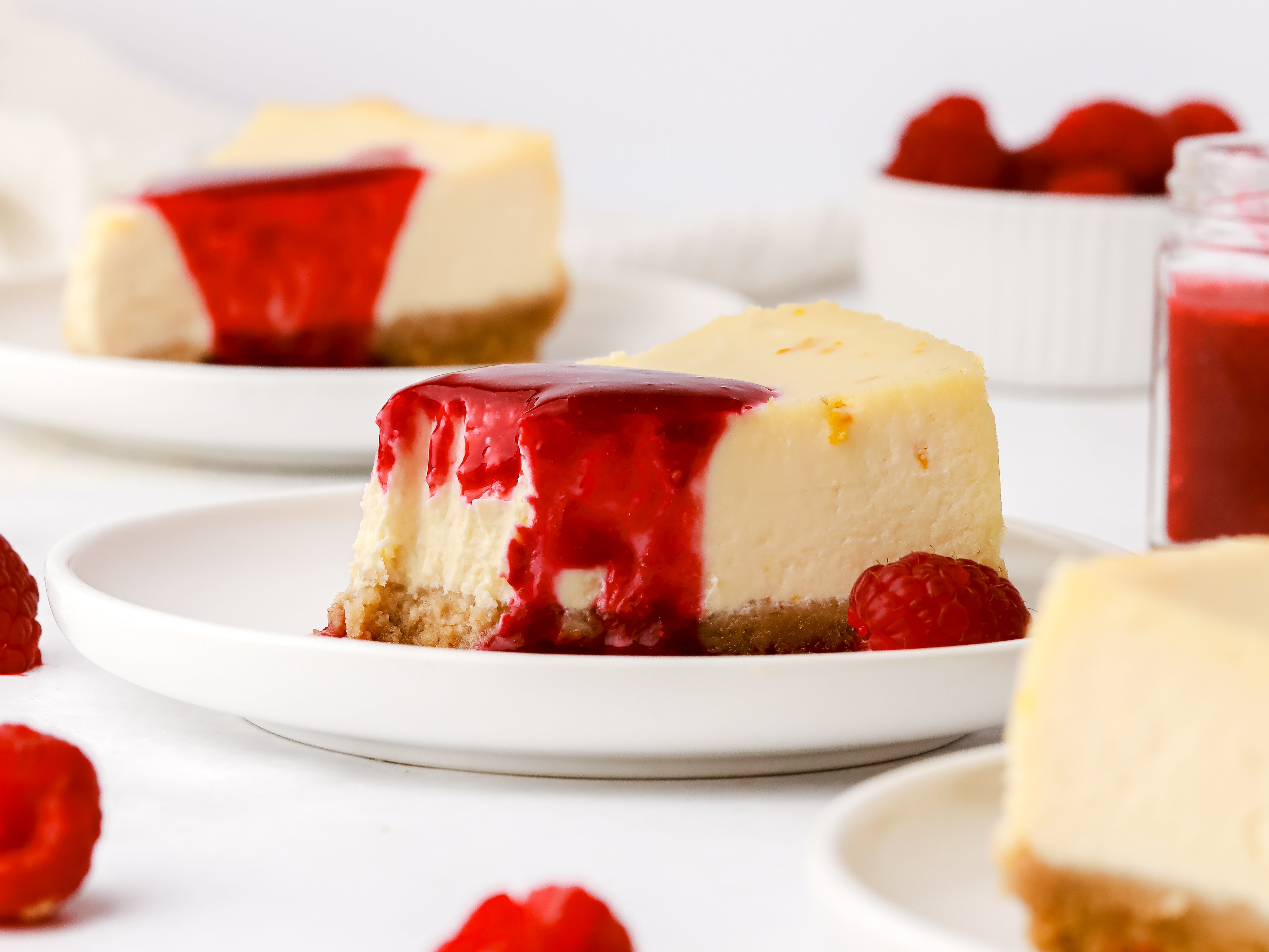 Slice of cheesecake with raspberry coulis on top