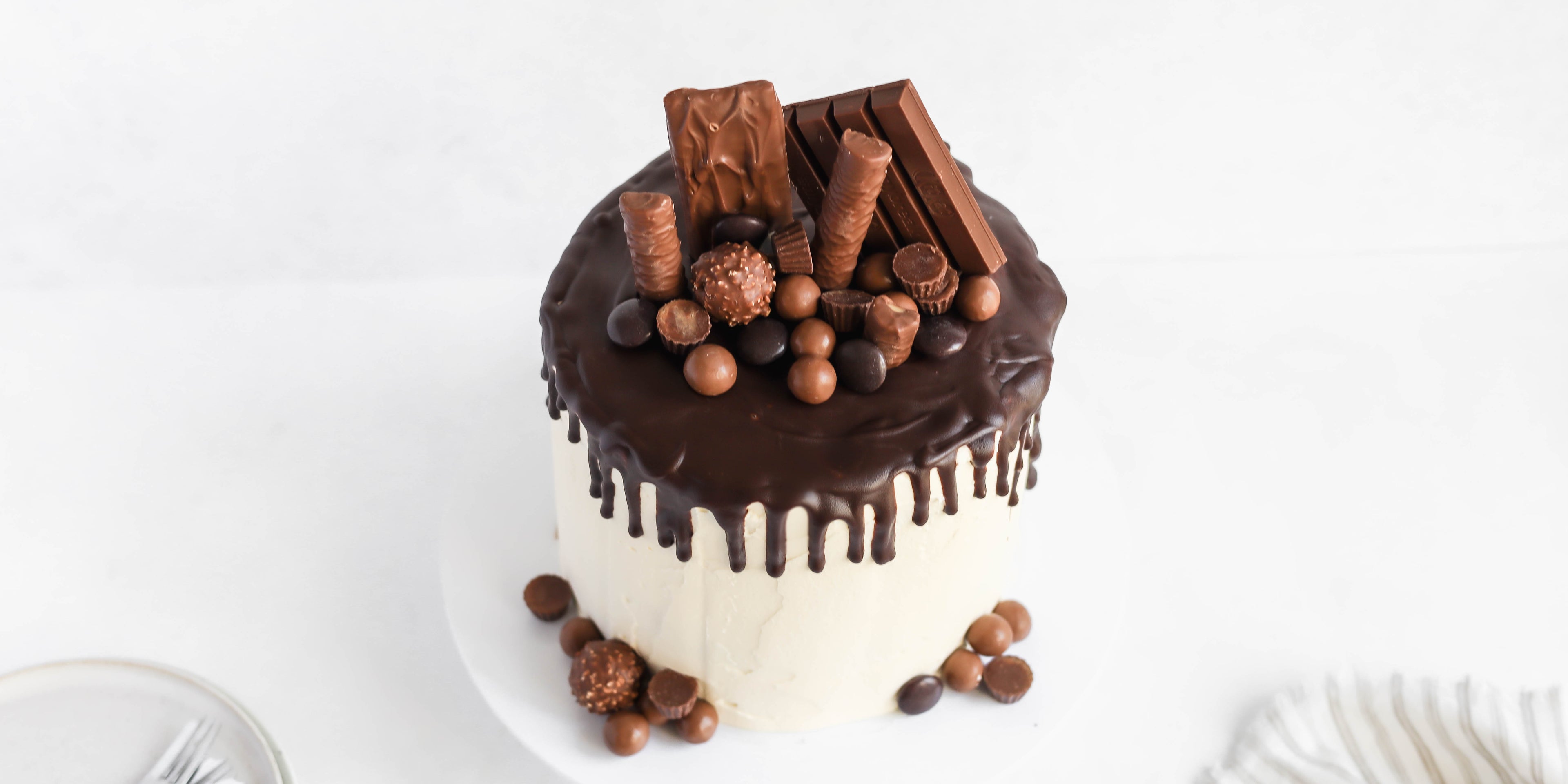 Top view of Ultimate Birthday Drip Cake topped with chocolate goodies