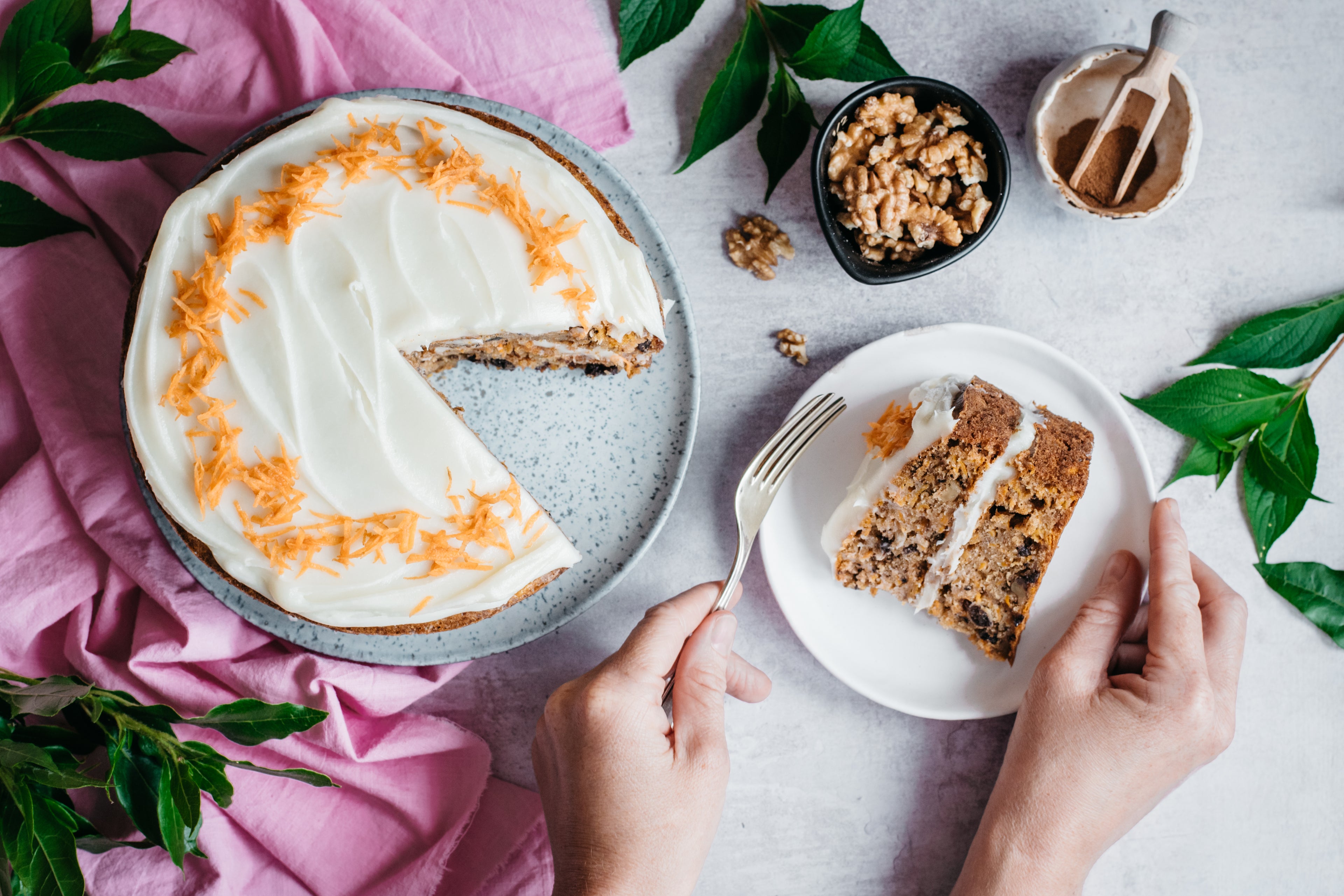 Top down view of a low sugar carrot cake with a slice cut out on plate