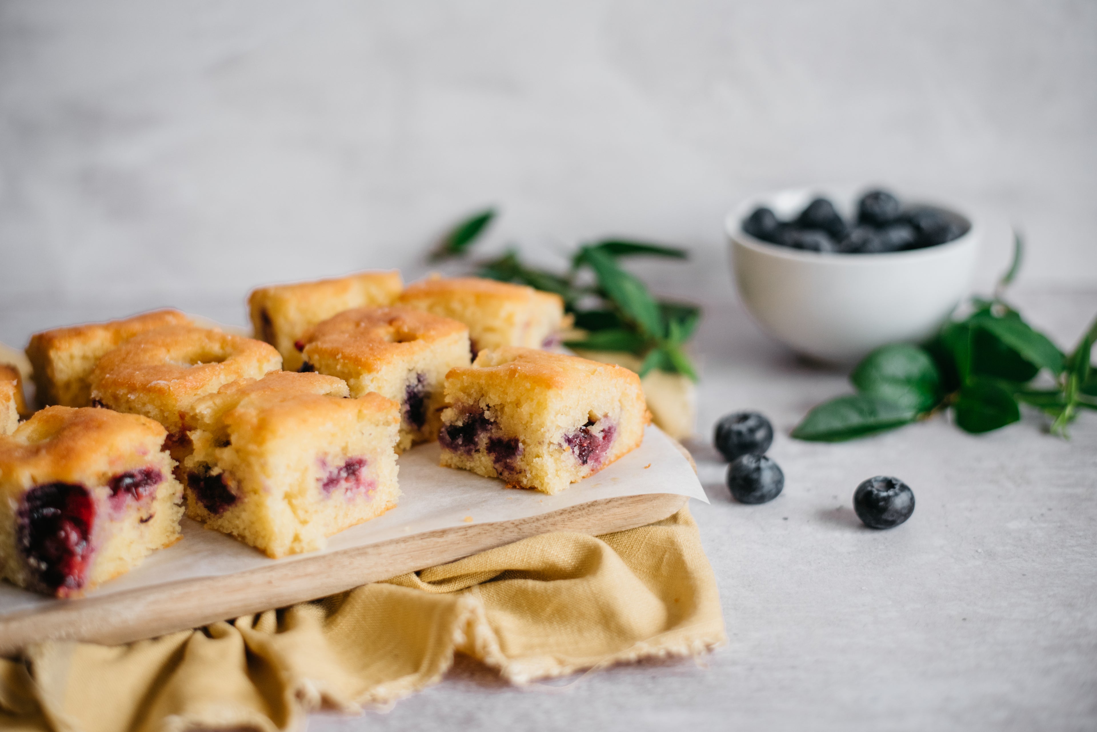 Side on close up of low sugar lemon and blueberry traybake