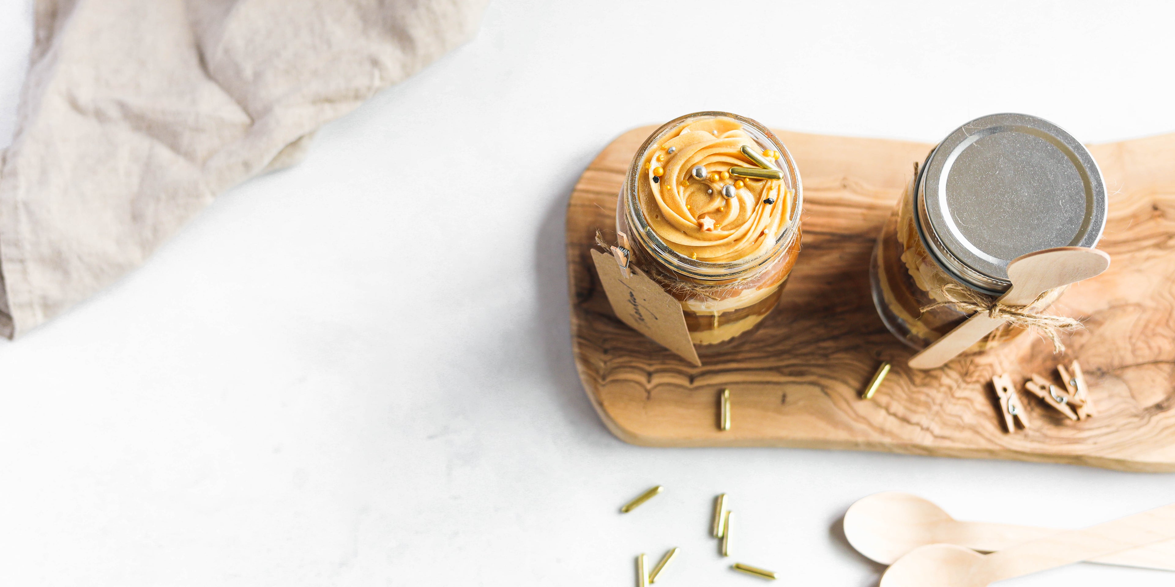 Flat lay of Chocolate & Salted Caramel Cupcakes in a Jar with sprinkles