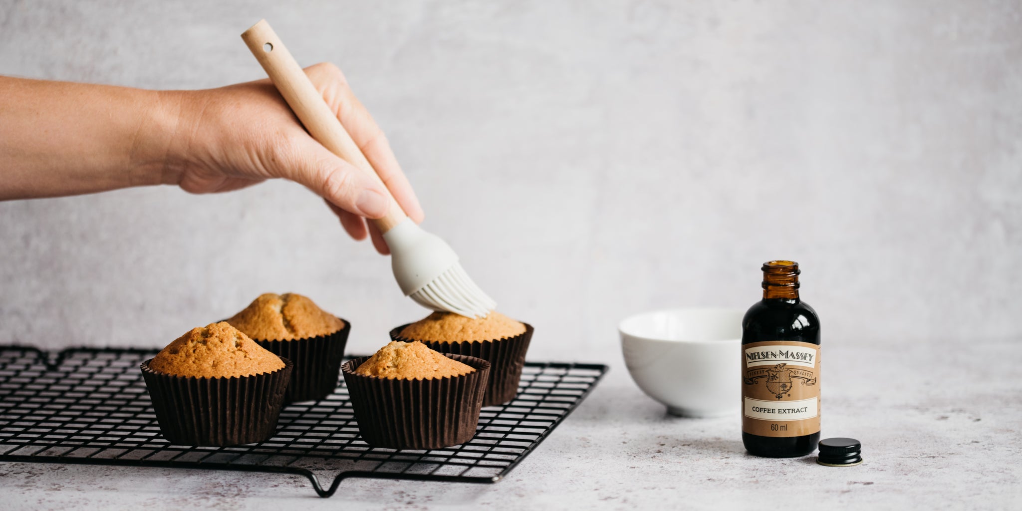 Coffee Cupcakes being brushed with Nielsen Massey coffee extract to give the cupcakes and rich, coffee flavour