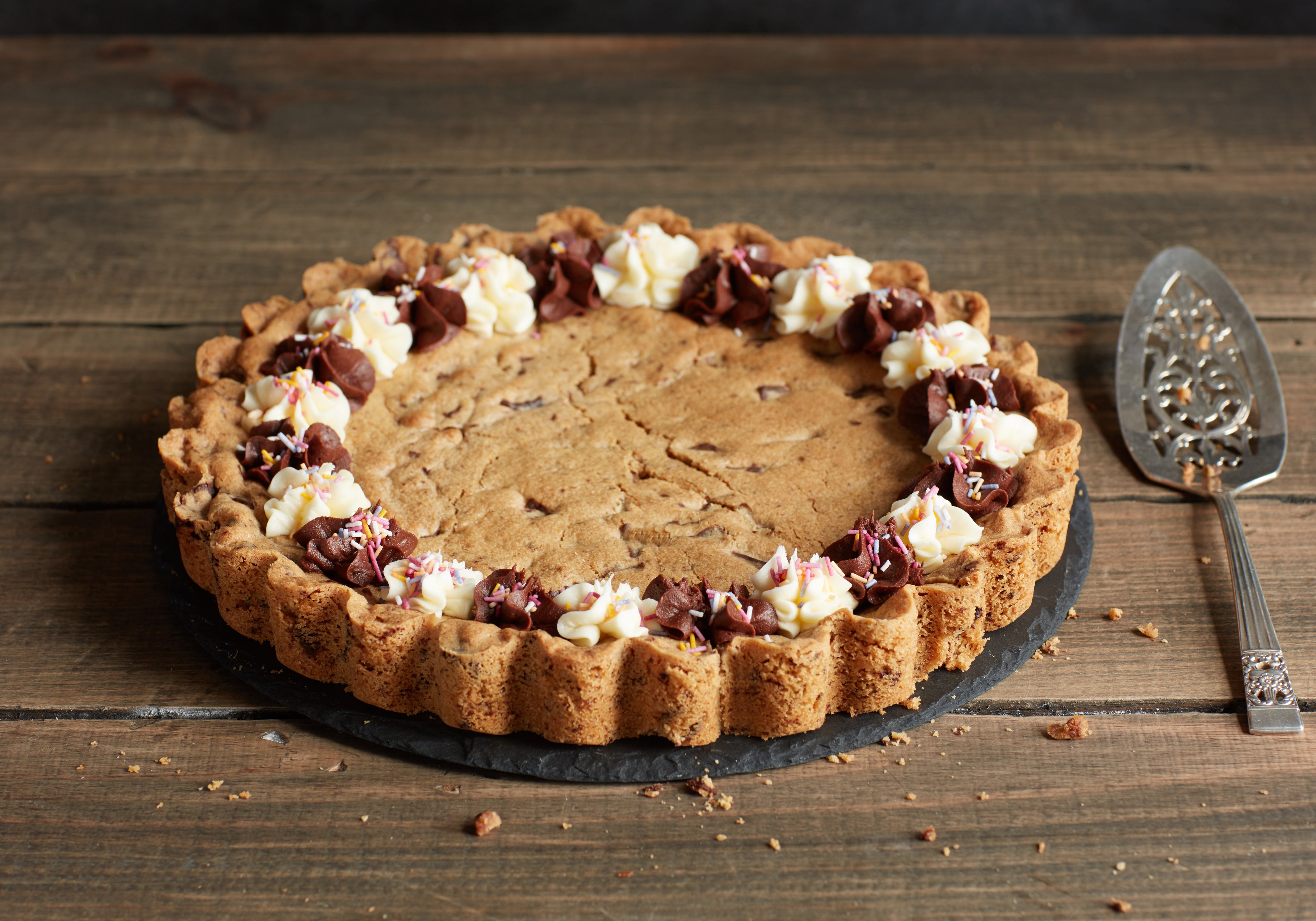 Giant Cookie Cake uncut with cake slice