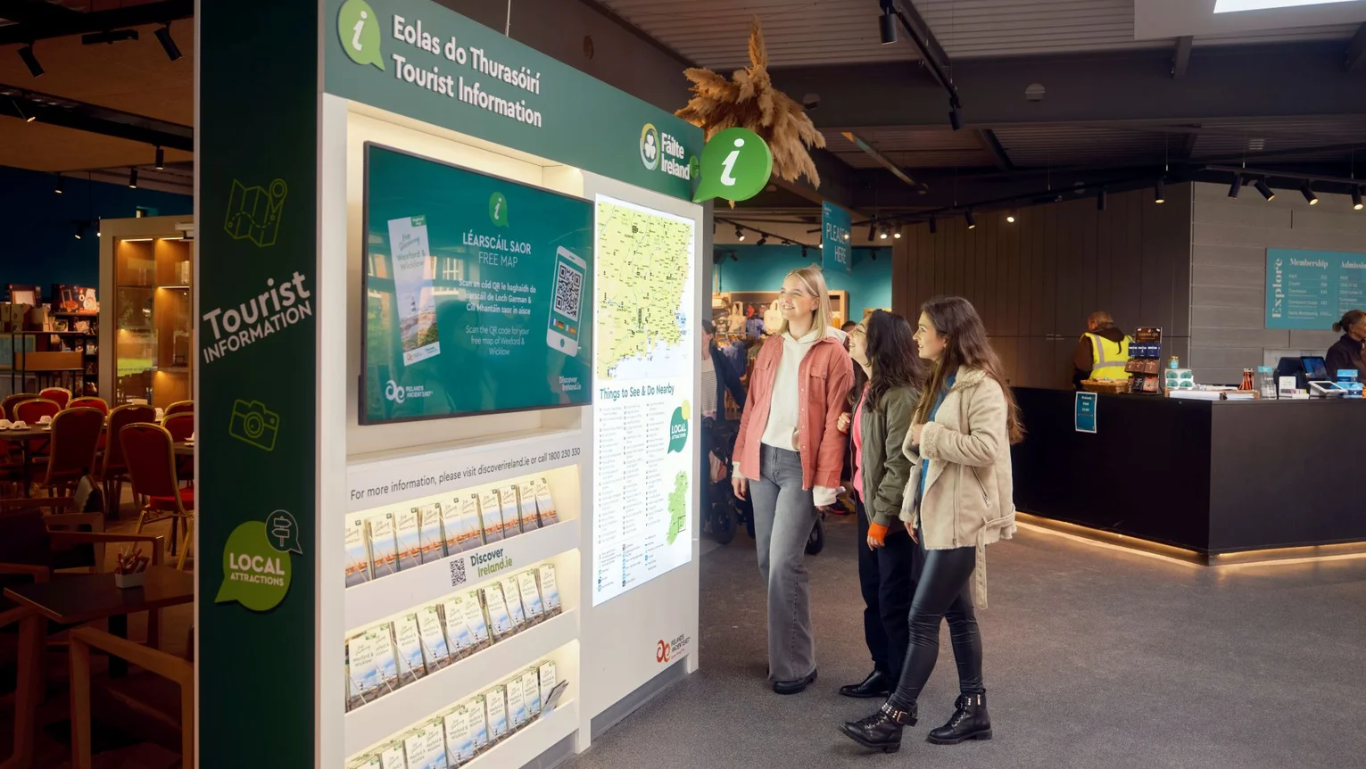 Visitors viewing information displays inside a tourist information centre