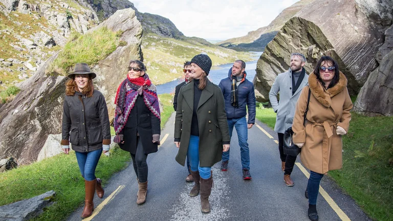 A group of people walking on a road