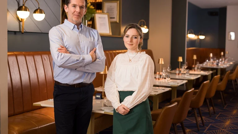Restaurant staff standing together in a fine dining restaurant