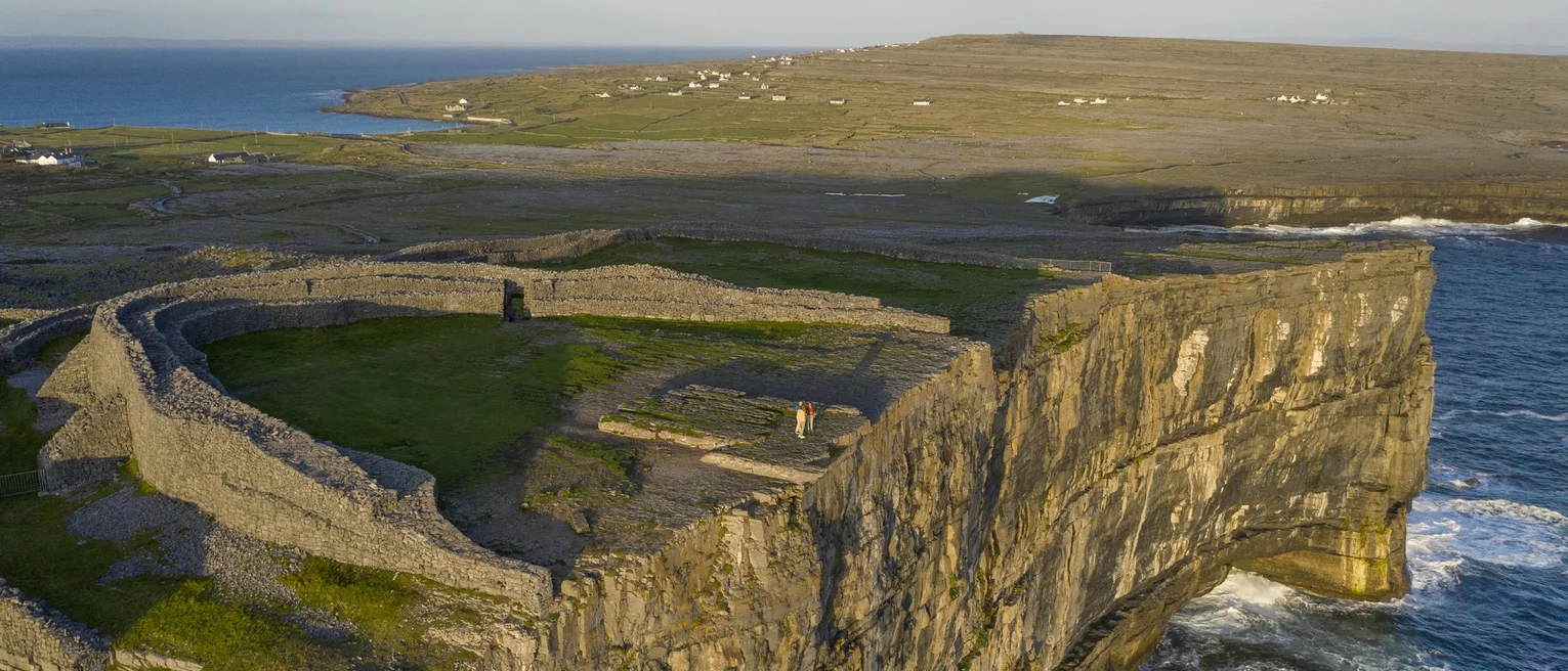 An arial view of sheer cliff faces dropping down to the sea.