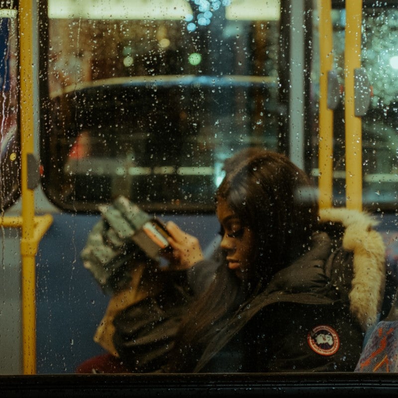 Person reading on a bus