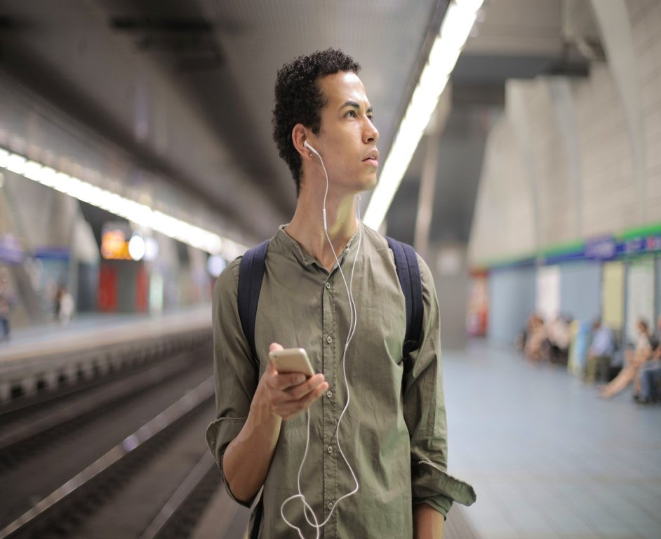 man at the station with a mobile