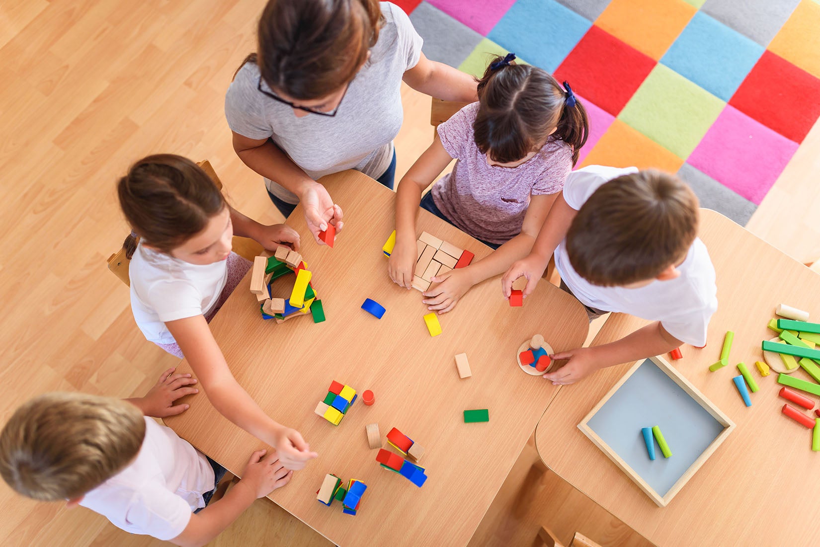 Children playing in classroom with building blocks