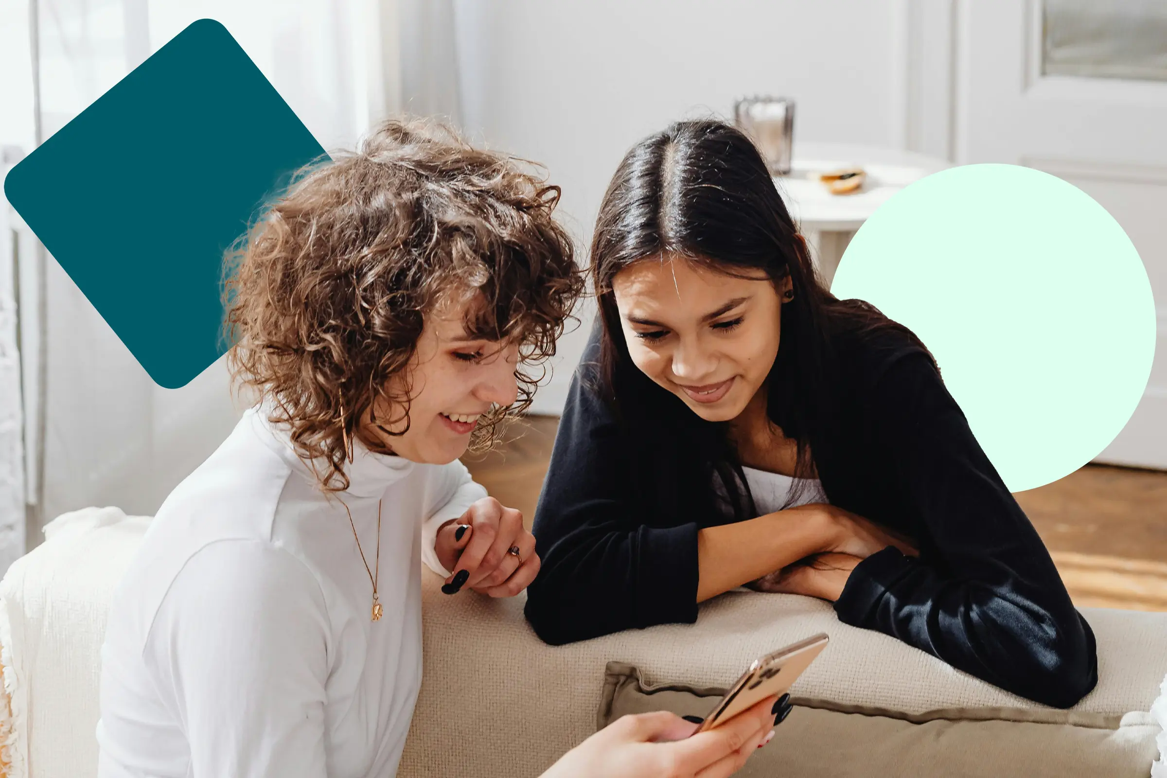 Two friends looking at a smartphone.