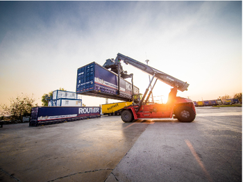 Forklift handling a container