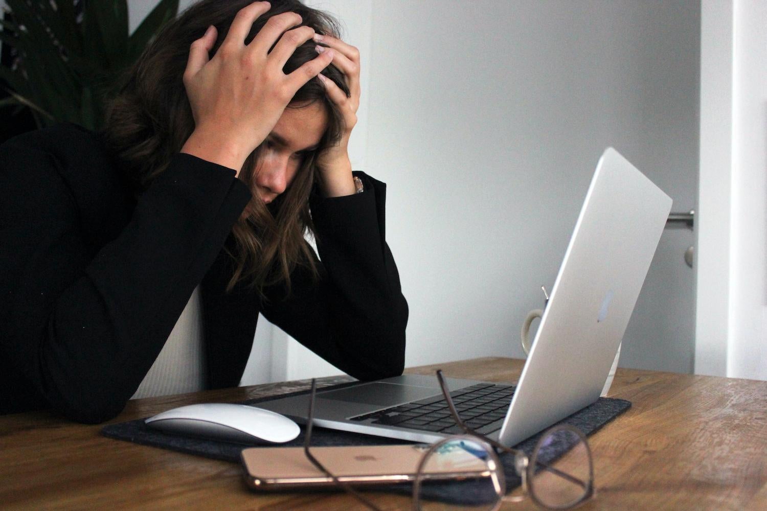 a frustrated person with an laptop