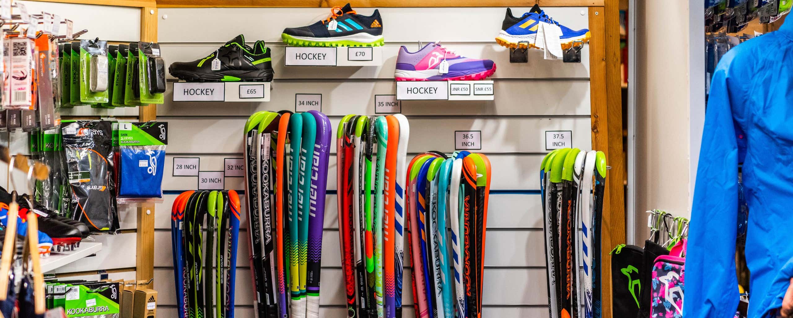 hockey sticks and trainers in shop