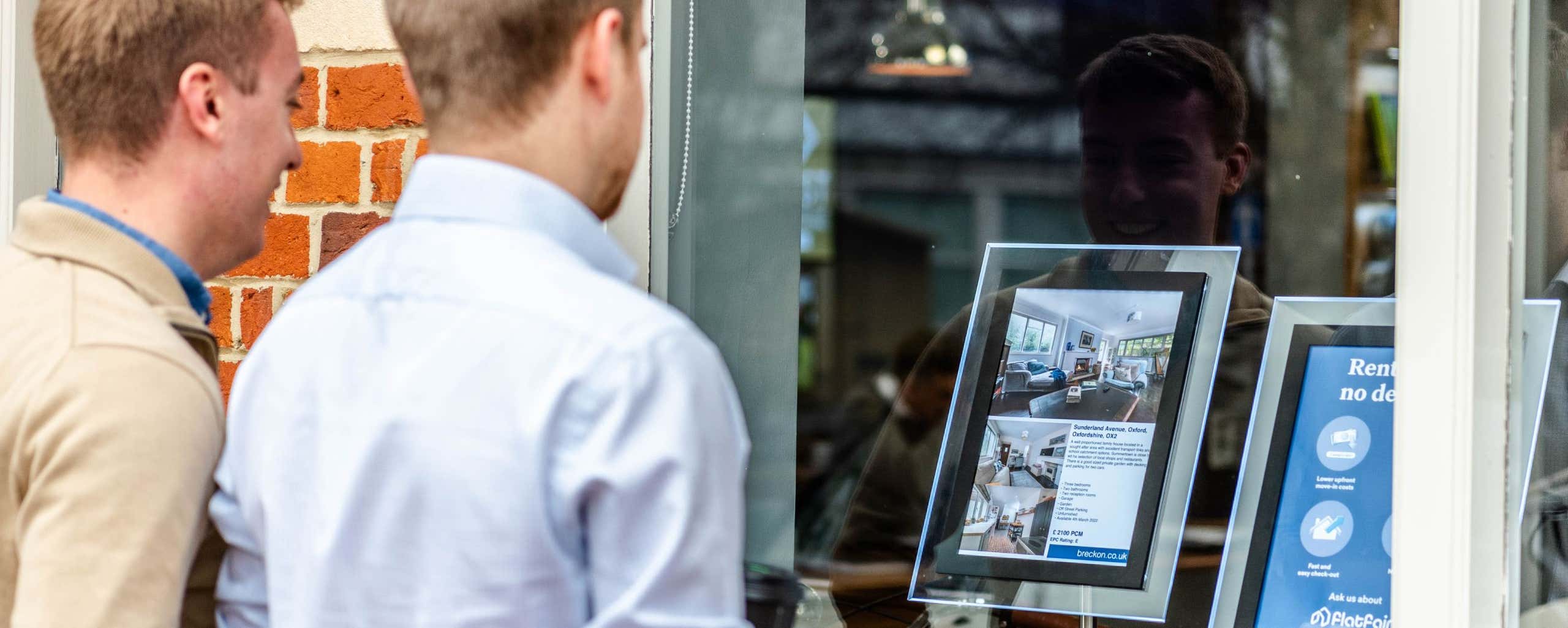 photo of two people looking at the shop front