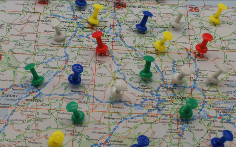 Coloured pins on a map of England, photo by Paul Marlow for Unsplash