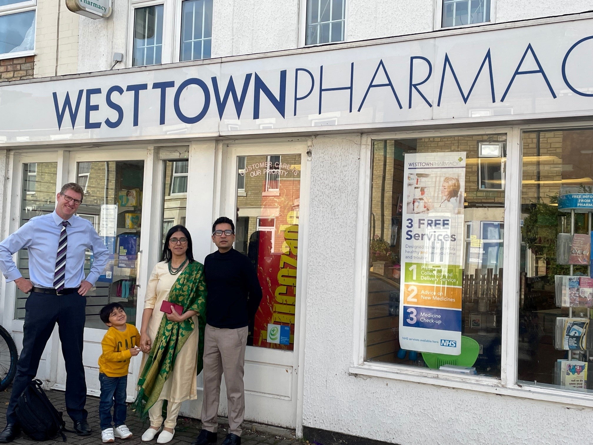 Christie & Co business agent with new owners of West Town Pharmacy in Peterborough