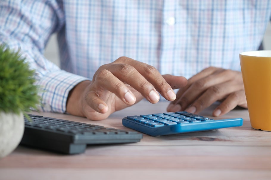Image of man using calculator, taken by Towfiqu barbhuiya for Unsplash