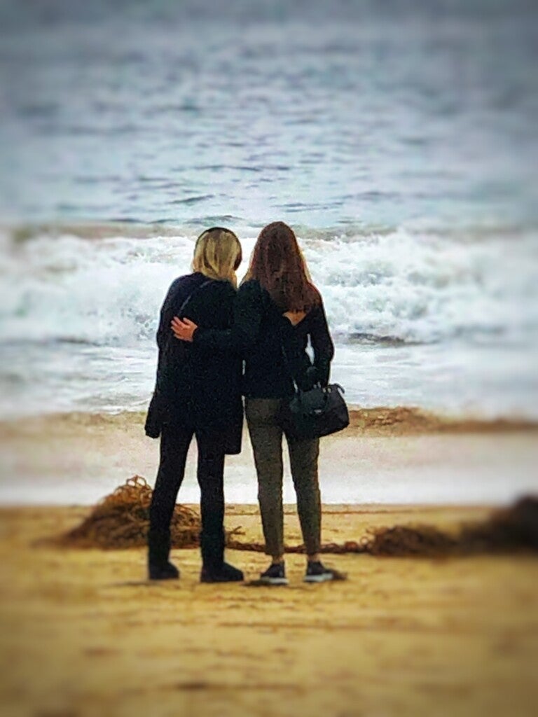 Aline und Christy stehen am Strand und schauen auf das Meer Aline und Christy stehen am Strand und schauen auf das Meer
