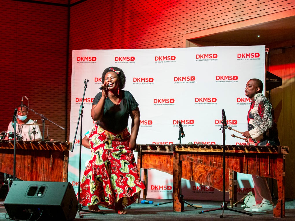 Die Marimba Band begleitete den Start von DKMS Africa, eine Frau sing in ein Mikrofon Die Marimba Band begleitete den Start von DKMS Africa, eine Frau sing in ein Mikrofon