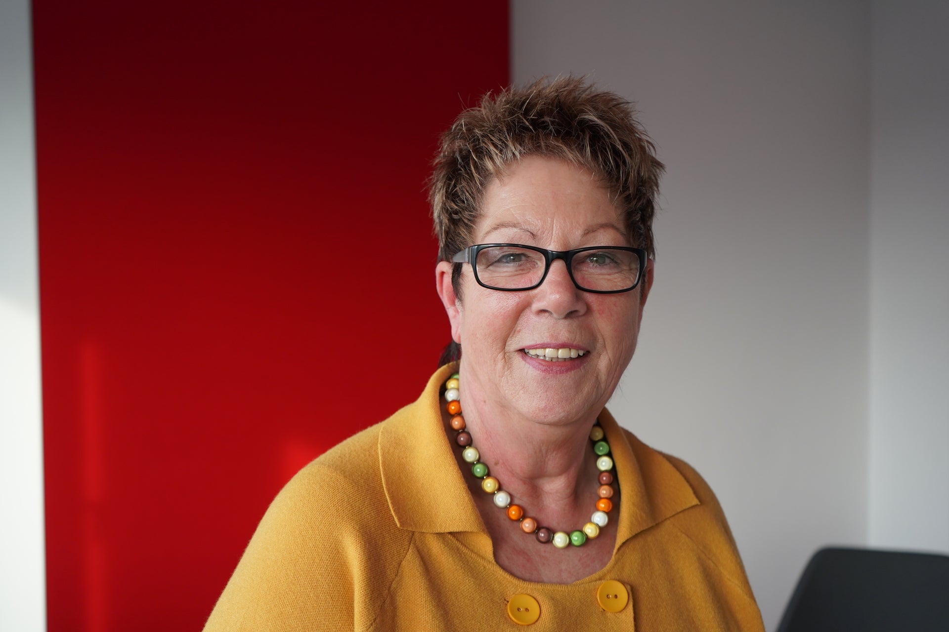 Eine Frau mit Brille und einem gelben Hemd Eine Frau mit Brille und einem gelben Hemd