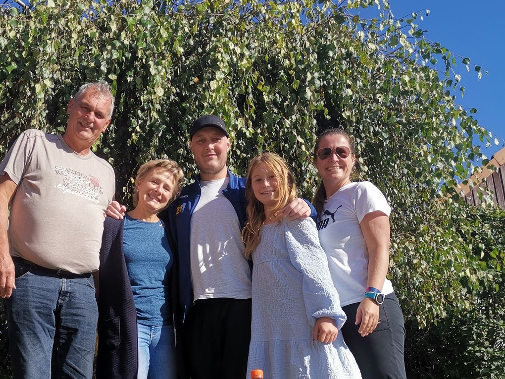 eine Familie posiert vor einem Baum eine Familie posiert vor einem Baum