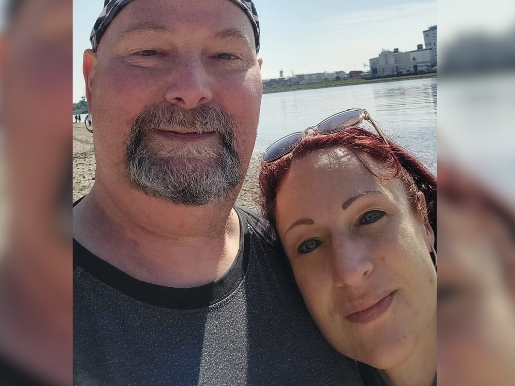Ein Mann und eine Frau machen ein Selfie in der Sonne vor einem Gewässer. Ein Mann und eine Frau machen ein Selfie in der Sonne vor einem Gewässer.
