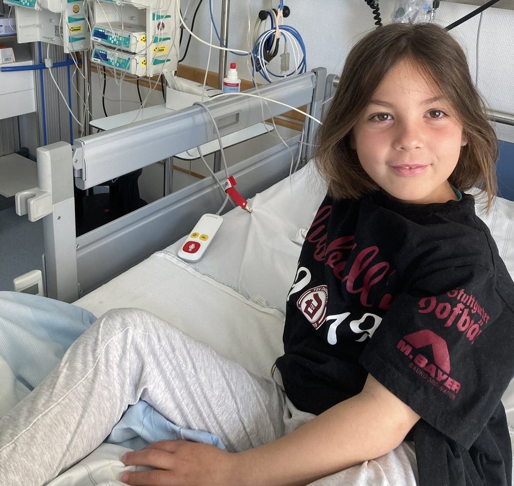 Ein Mädchen sitzt in einem Krankenhausbett Ein Mädchen sitzt in einem Krankenhausbett