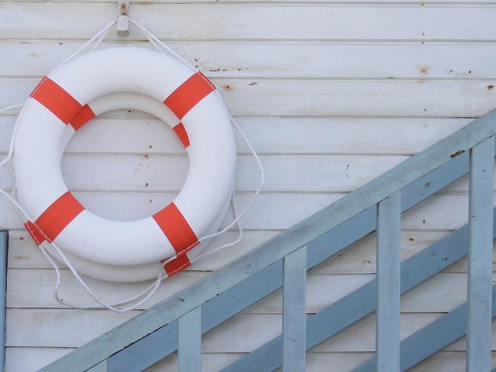 Ein weiß-roter Rettungsring an einer Wand Ein weiß-roter Rettungsring an einer Wand