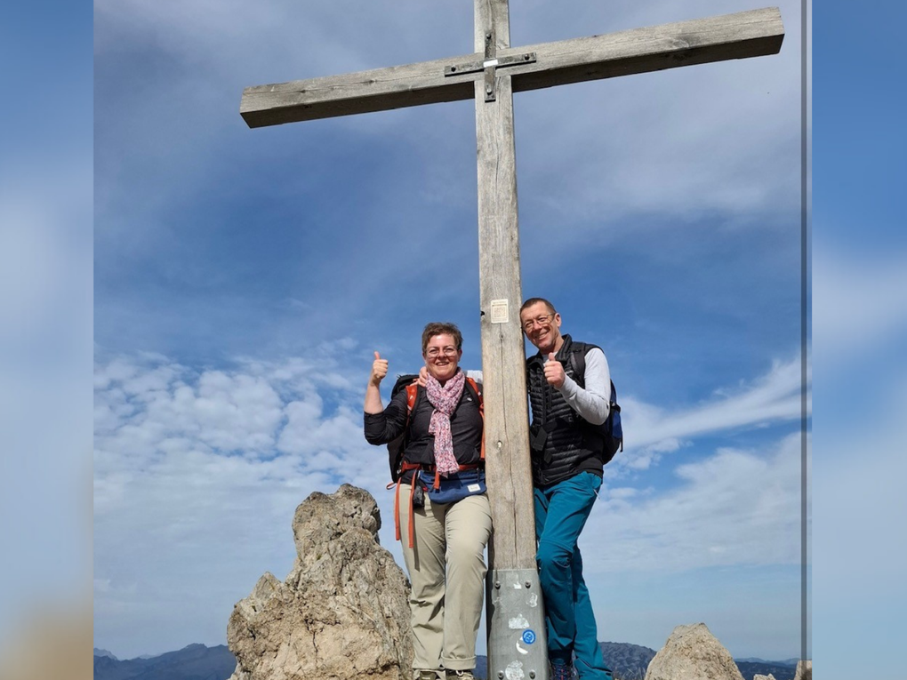 Ein Mann und eine Frau stehen neben einem Kreuz Ein Mann und eine Frau stehen neben einem Kreuz